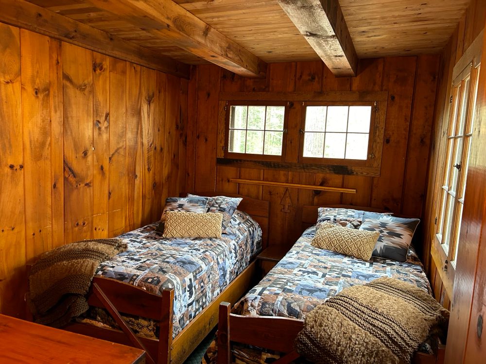 Adirondack cabin bedroom with twin beds and rustic style