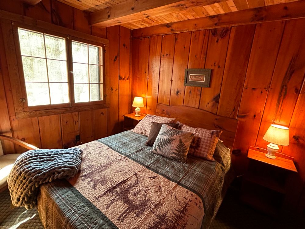 Bedroom with Adirondack decor at Porter's Cottages